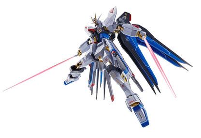 White, blue, and black Gundam mobile suit with large wings, wielding two glowing red beam sabers dynamically