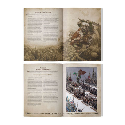 Open fantasy wargamer guide book showing an Ork fighting a Dwarf illustration and a photo of miniature armies led by a green dragon