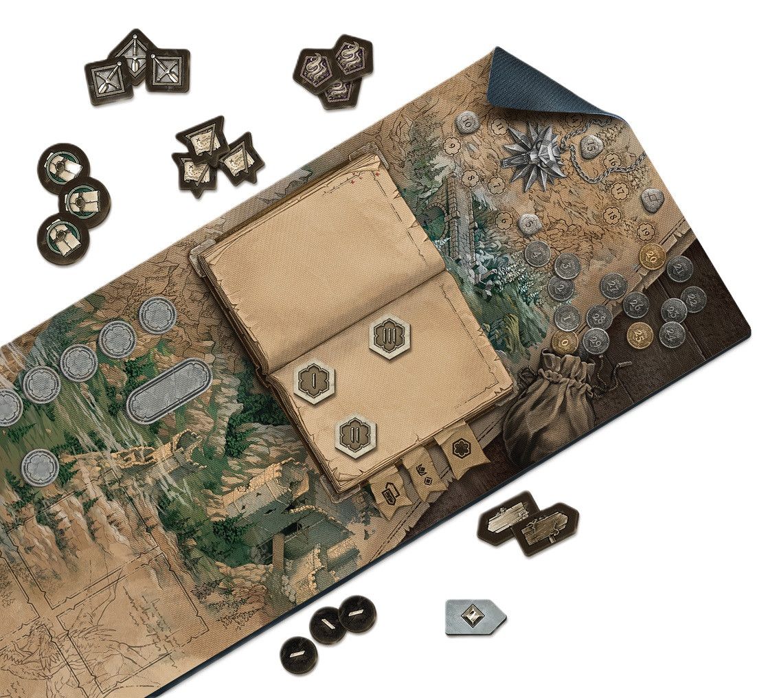 Tabletop fantasy game setup: a detailed map mat, open lore book with tokens, scattered coins and game pieces