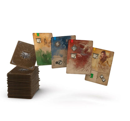 A stack of game cards with a silver wolf emblem, and colorful character cards with figures and symbols fanned out
