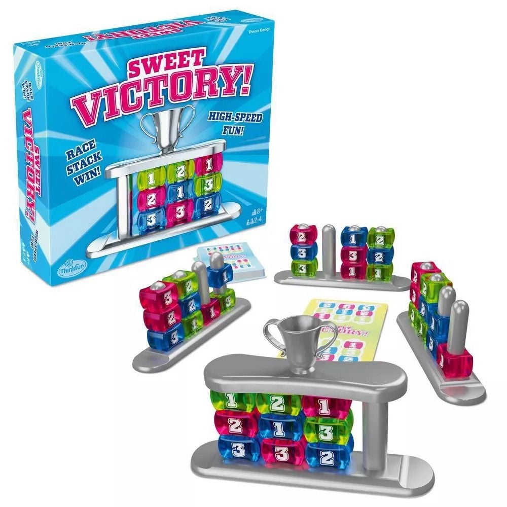 Sweet Victory! board game box and pieces: colourful translucent numbered blocks stacked on grey bases with silver posts, plus a silver trophy