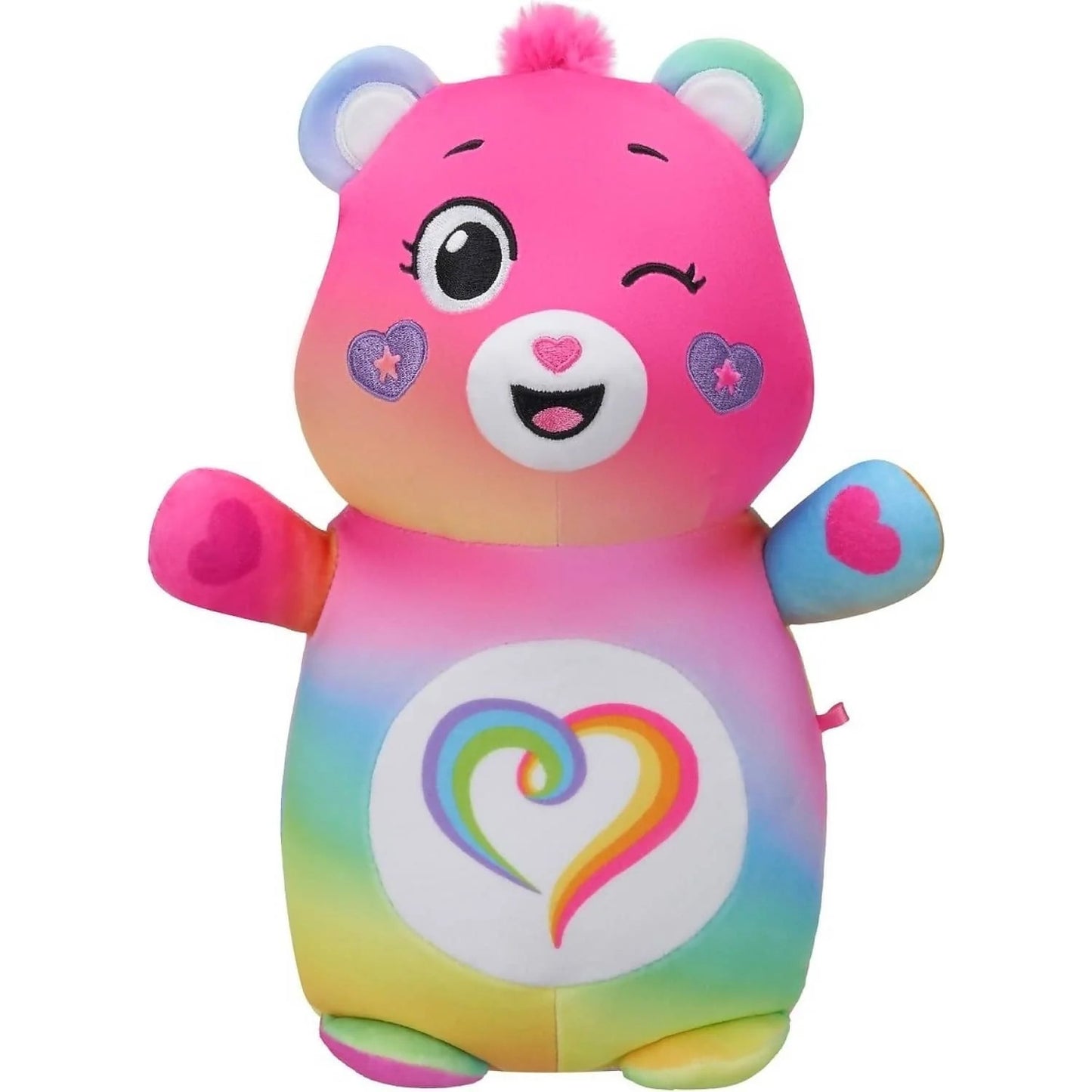 Rainbow ombre Care Bear plush toy winking, with a pink pom pom and a colorful heart belly badge