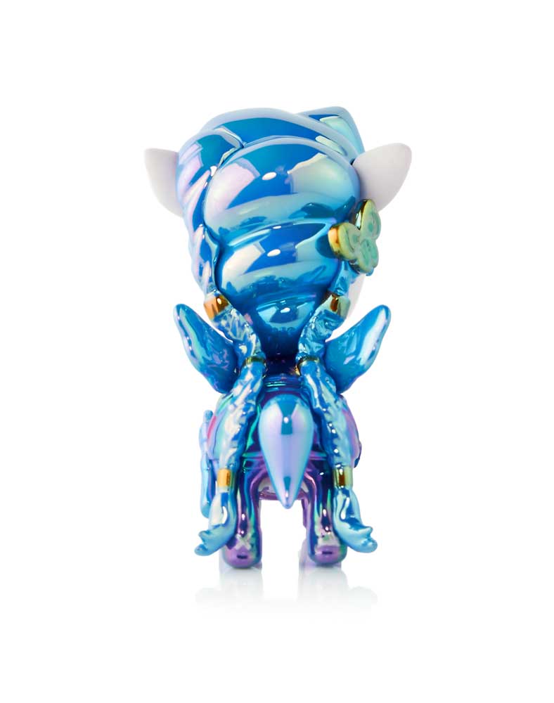 Back view of a glossy, iridescent blue and purple creature figurine with white ears and gold accents