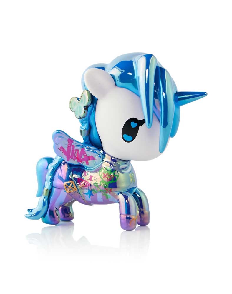 Glossy iridescent blue-purple unicorn toy with a white face, blue mane/horn, and colorful graffiti patterns
