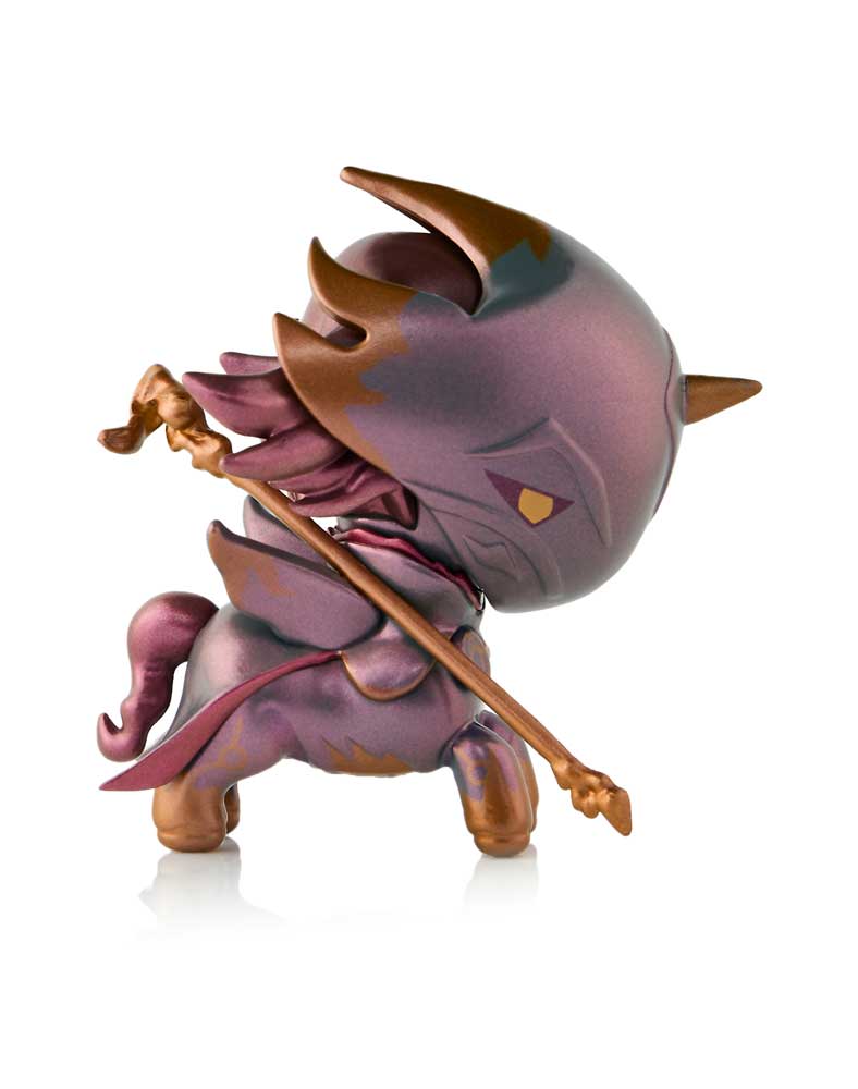 Stylized purple & gold horned creature figure with a large head & horse-like body, holding a golden staff