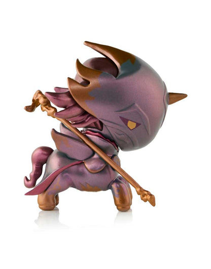 Stylized purple & gold horned creature figure with a large head & horse-like body, holding a golden staff