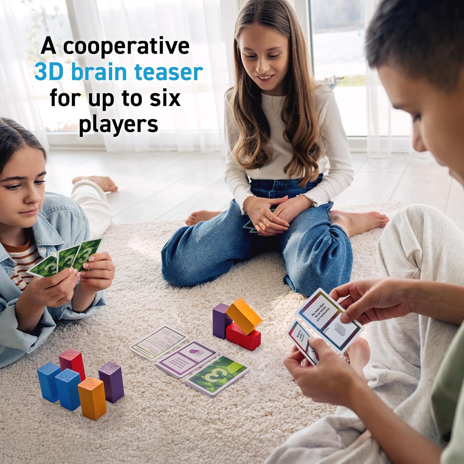 Three children play a cooperative 3D brain teaser game on a rug with cards and colorful blocks