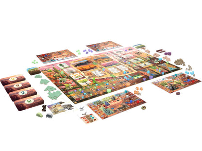 Colorful desert-themed board game laid out, showing multiple landscape boards, animal cards, and various game pieces