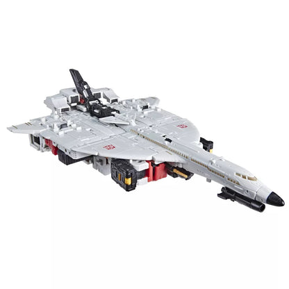 A white and gray Transformer toy jet with black engines, red accents, Decepticon symbols, and a smaller black jet mounted on top