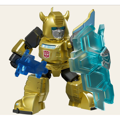 A stylized gold robot with an Autobot symbol, blue visor, and horns, holding a translucent blue blaster and shield