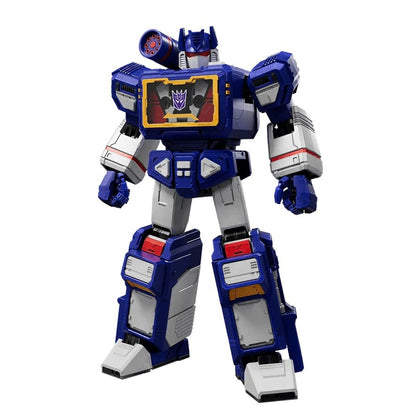 Blue, white, and red Soundwave Transformer action figure standing, features a cassette player chest with a Decepticon symbol and a shoulder-mounted cannon