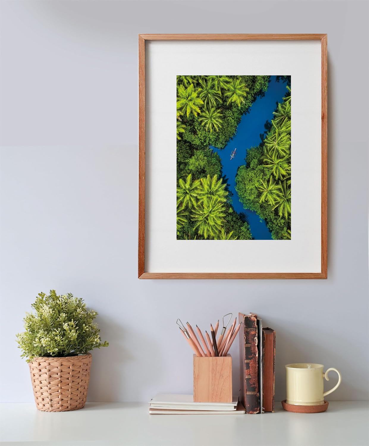 Aerial photo of a small boat on a winding blue river, surrounded by dense green palm trees