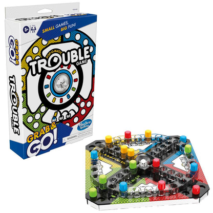 A Trouble Grab & Go! board game box and compact game board with colorful player pegs and a central dice popper