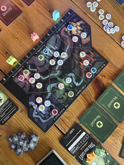 A dark game board, player pieces, tokens, and cards from the Twisted Cryptids Cryptid Culture Expansion game are laid out on a wooden table