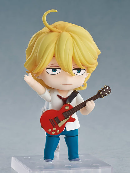 Blond Nendoroid figure with blue eyes, in a white shirt and blue pants, holding a red electric guitar, left arm raised