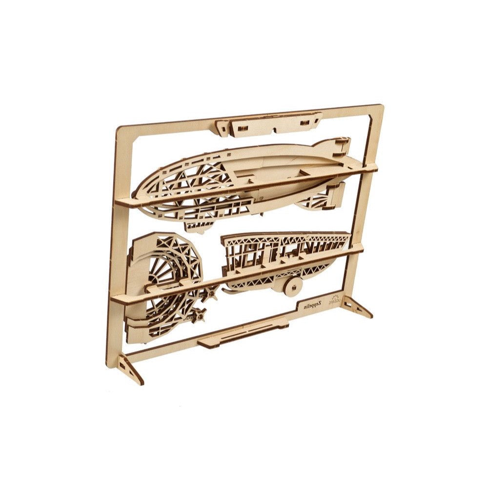 Unassembled laser-cut wooden airship 3D puzzle kit, with parts still attached to the frame