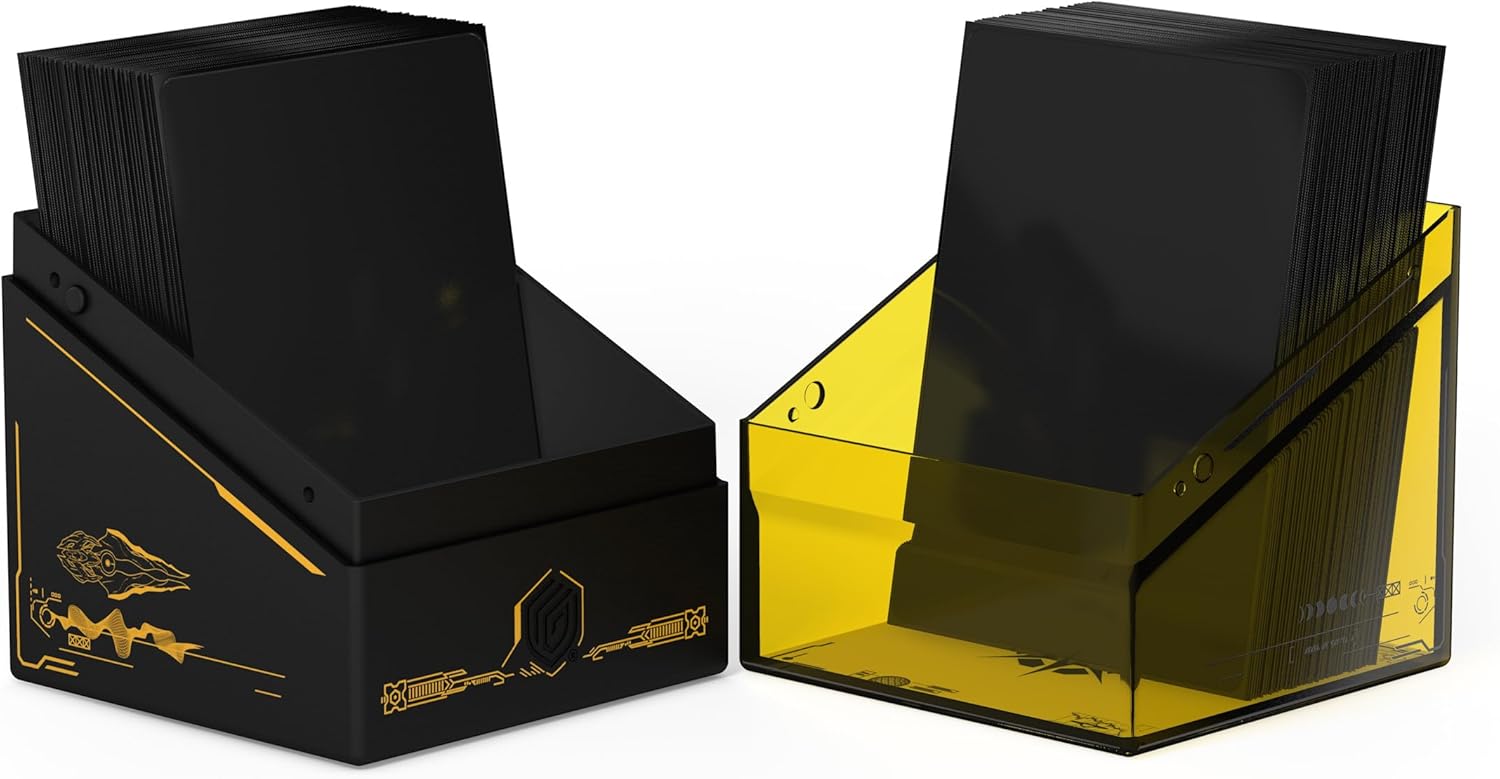 Two card deck boxes: one black with gold sci-fi designs, one translucent yellow, both filled with black game cards