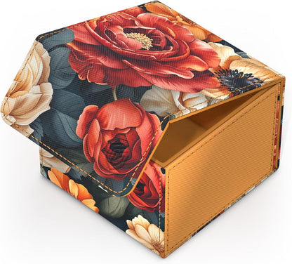 An open floral storage box with vivid red and cream flowers on a dark background, revealing its golden-yellow interior