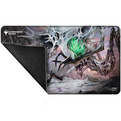 Magic: The Gathering Commander playmat shows a white skeletal creature with a glowing green core. Its black rubber underside is visible
