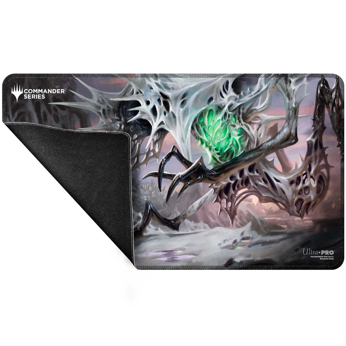 Magic: The Gathering Commander playmat shows a white skeletal creature with a glowing green core. Its black rubber underside is visible