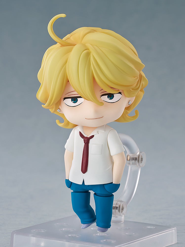 Nendoroid figure of a boy with blond hair, blue eyes, white shirt, red tie, and blue pants, smirking on a stand