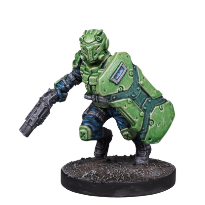 A miniature sci-fi soldier in green armor, wielding a shield and rifle, in a crouched pose