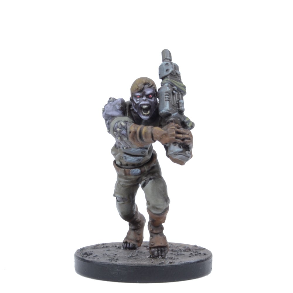 A miniature zombie figure with red eyes and an open mouth, lunging forward while holding a futuristic rifle