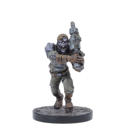 A miniature zombie figure with red eyes and an open mouth, lunging forward while holding a futuristic rifle