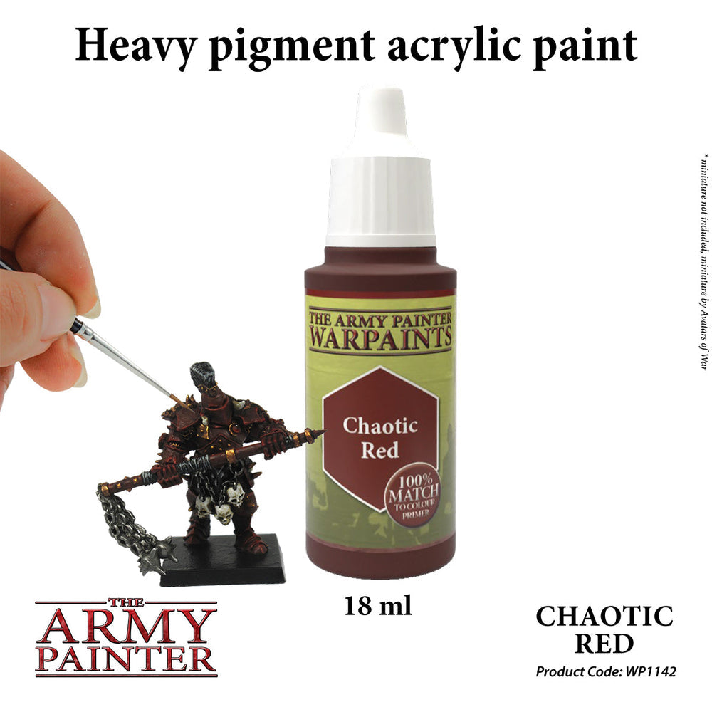 The Army Painter Chaotic Red paint bottle next to a hand painting a miniature figure