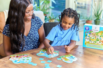 Mother and daughter playing Peter Rabbit Veg Patch Lotto board game on a wooden table