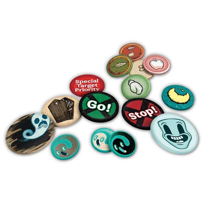 A collection of Vagrantsong Deluxe game tokens featuring vibrant cartoon designs like ghosts, a smiling blue face, coffins, and red and green Go and Stop signs