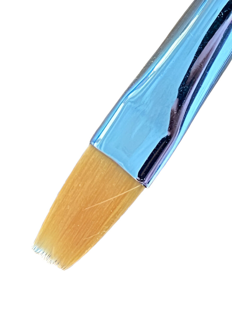 Close-up of a flat makeup brush with light brown bristles and a shiny blue metallic ferrule