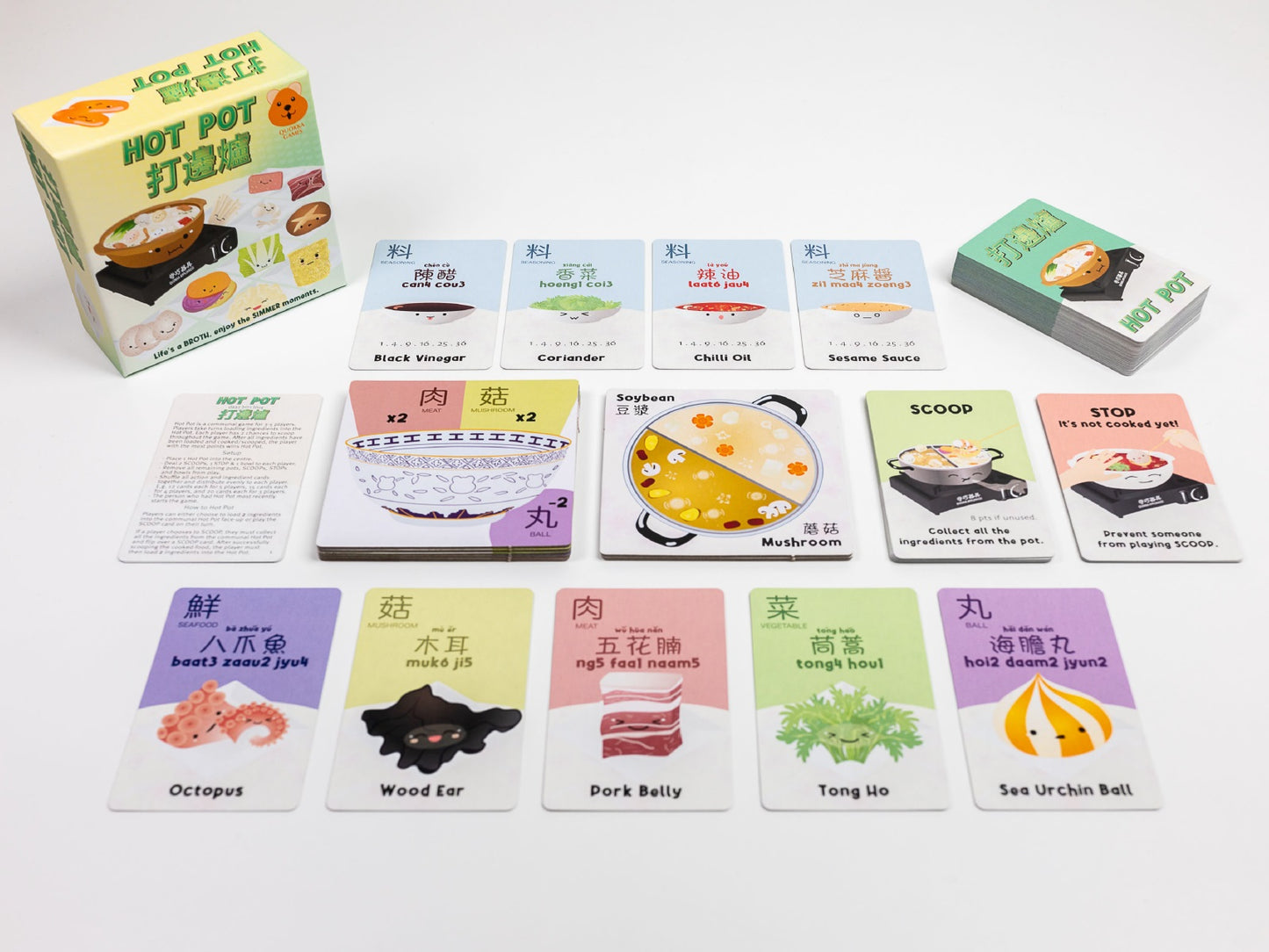 Tabletop view of the "Hot Pot" card game, featuring the box and various illustrated food ingredient cards