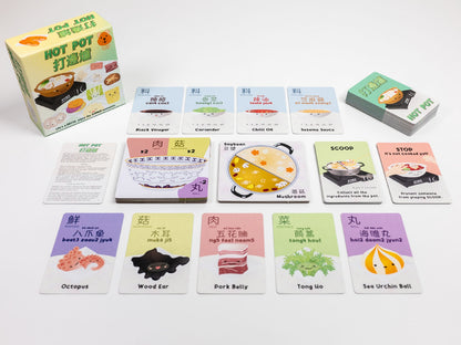 Tabletop view of the "Hot Pot" card game, featuring the box and various illustrated food ingredient cards
