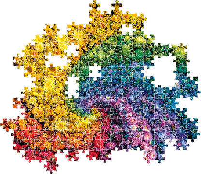 An incomplete jigsaw puzzle depicting a vibrant rainbow gradient of flowers