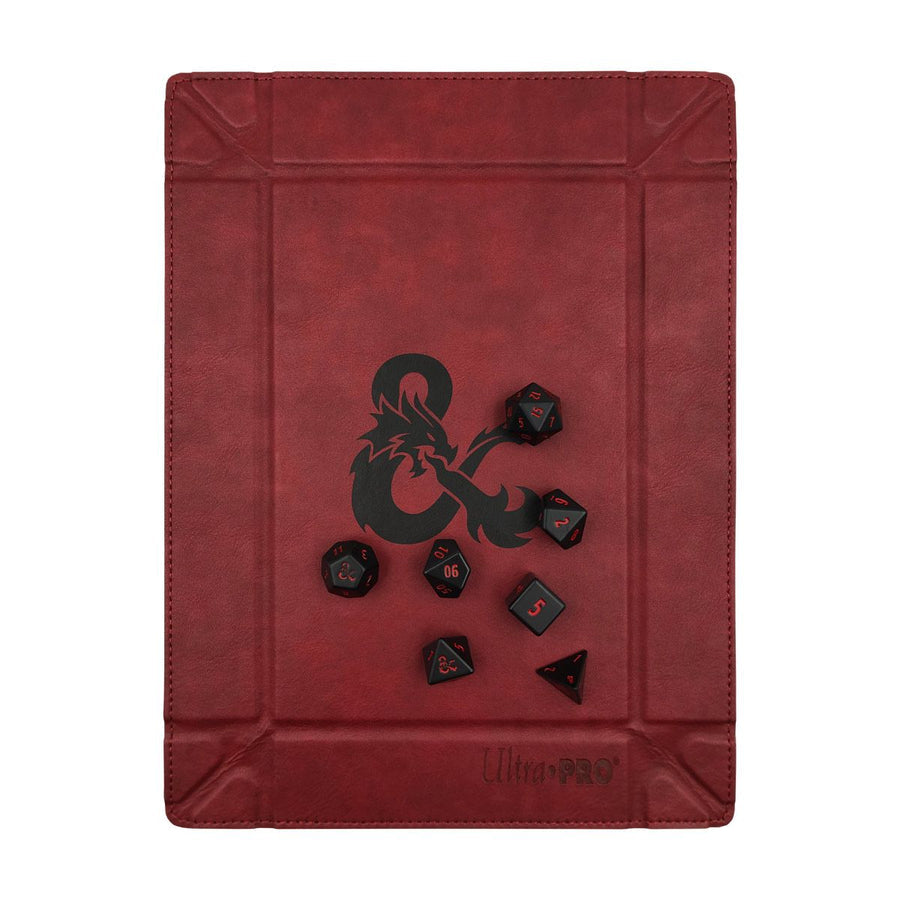 Red foldable dice tray with black Dungeons &amp; Dragons logo and a set of seven black polyhedral dice with red numbers, branded Ultra Pro