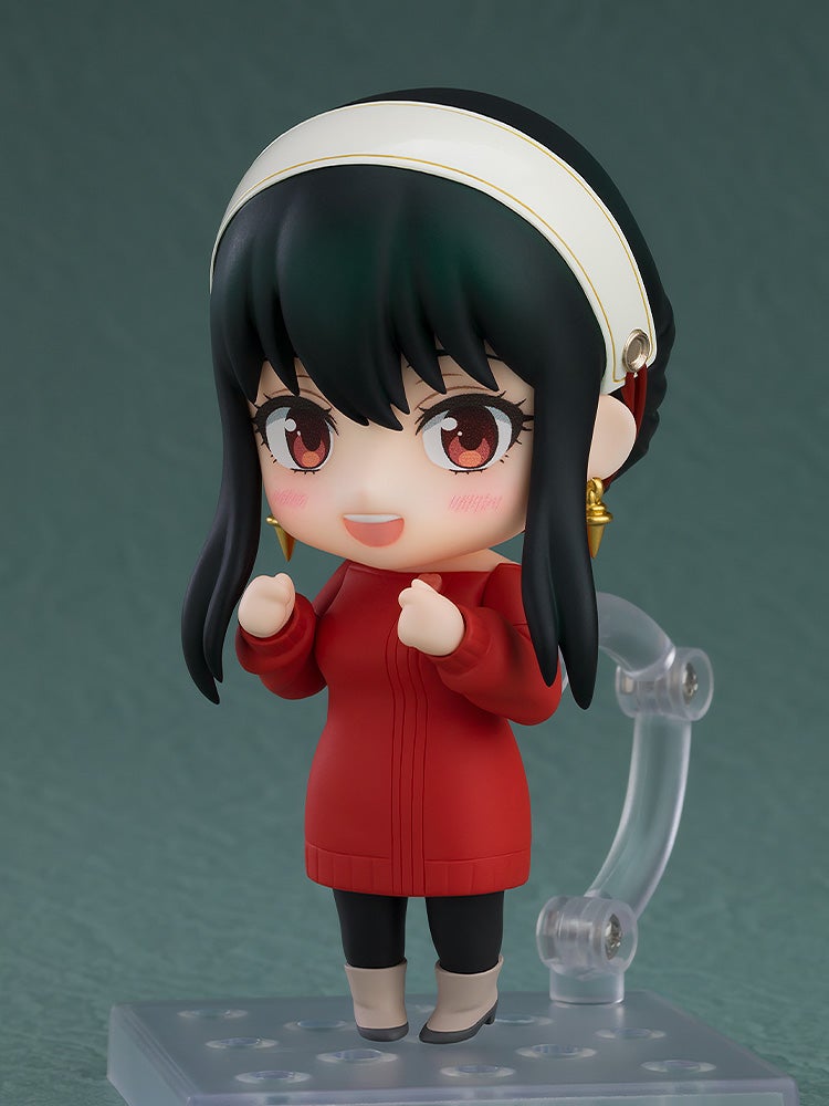 Nendoroid Yor Forger figure with black hair, white headband, and red dress, smiling with rosy cheeks and raised hands