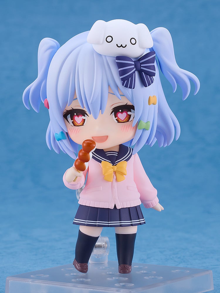 Chibi anime figure with blue hair, pink jacket, heart pupils, smiling and holding dango