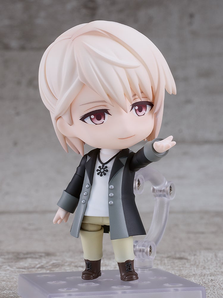 Nendoroid figure of an anime boy with blonde hair, red eyes, in a black and gray coat, pointing forward confidently.
