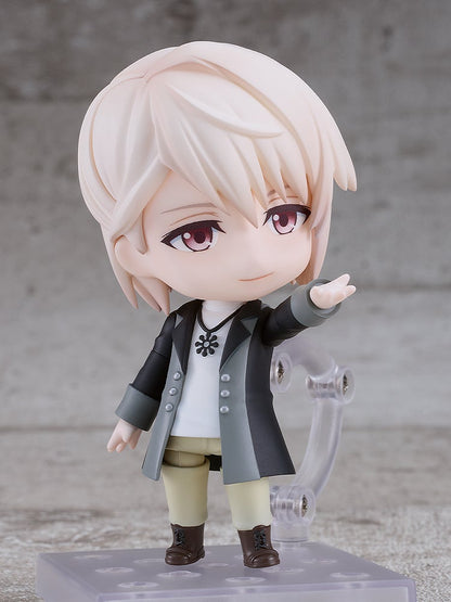 Nendoroid figure of an anime boy with blonde hair, red eyes, in a black and gray coat, pointing forward confidently.