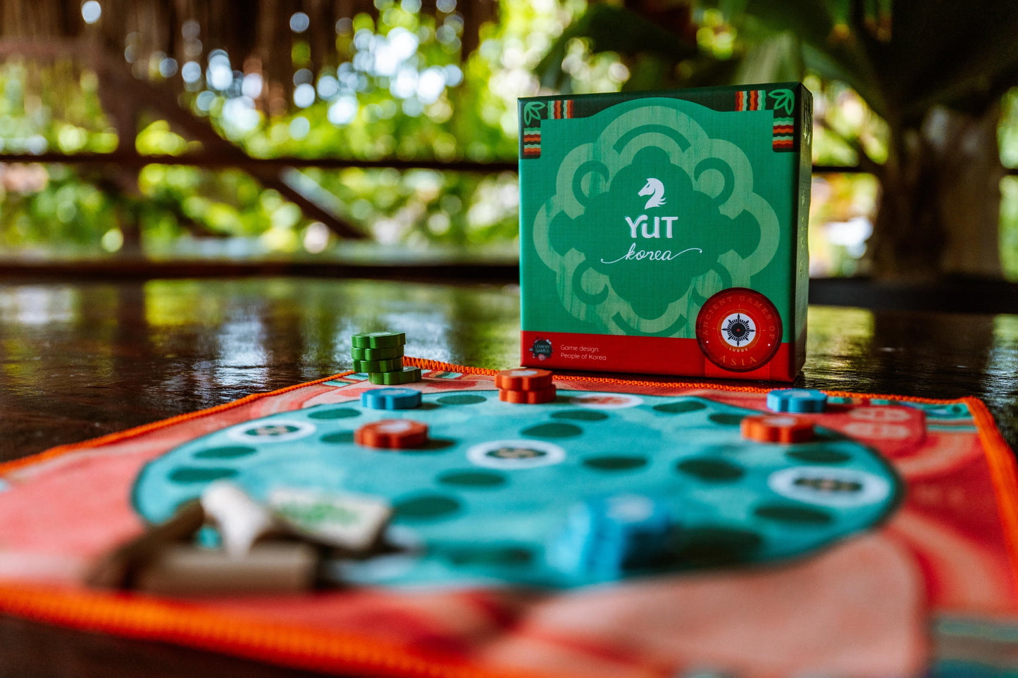 Yut game setup with traditional sticks and a circular board