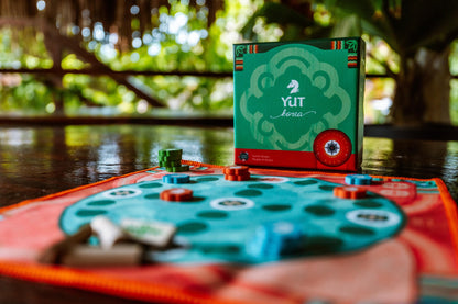Yut game setup with traditional sticks and a circular board