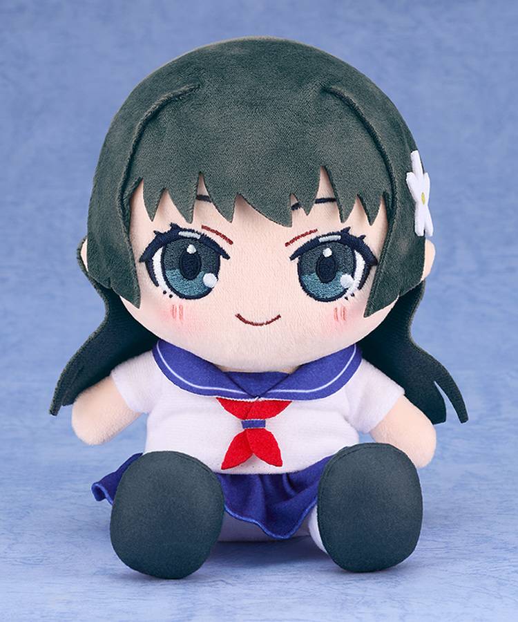 Angled view of the plushie showing her sitting position with visible skirt folds and soft fabric texture