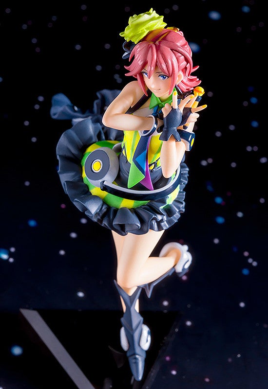 Anime figurine of a female character with pink hair wearing a colorful outfit and posing on a dark background with stars