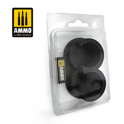 Two black circular model bases in a clear blister pack, with AMMO by MIG Jimenez branding.