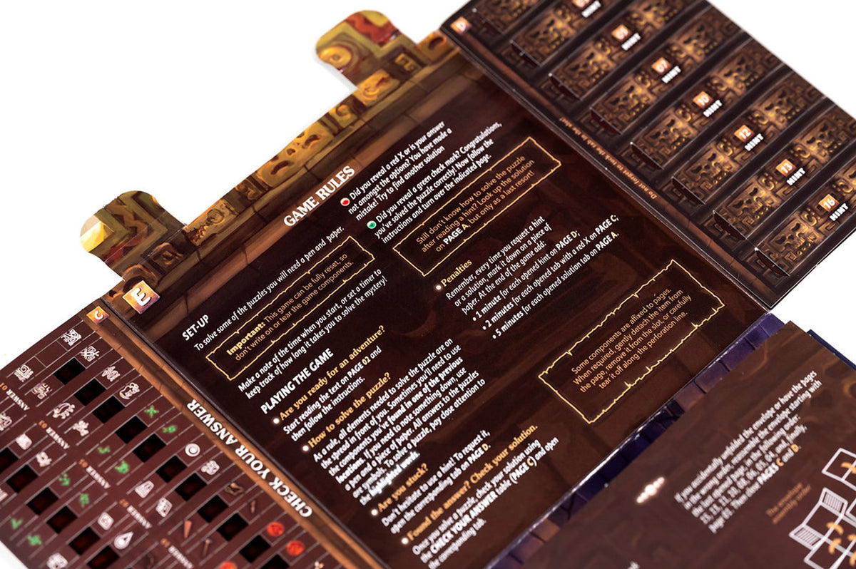 Unfold: Victim of the Pyramid gameplay setup showing fold-out sheets, illustrated cards, and puzzle components arranged for play