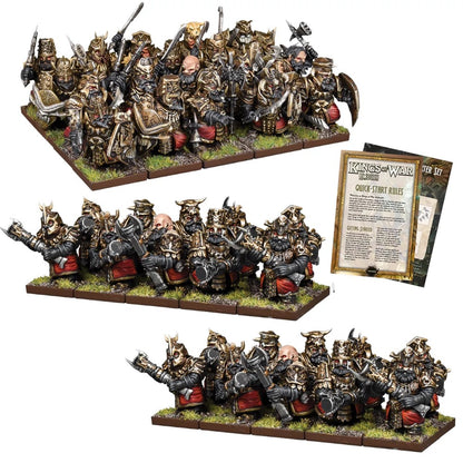 Armored dwarf wargame miniatures in gold and red, alongside a 'Kings of War Ambush' quick-start rulebook