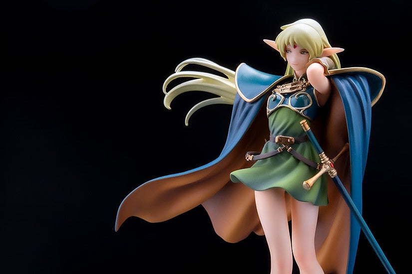 Anime figure of a female elf in green dress and blue cape holding a sword