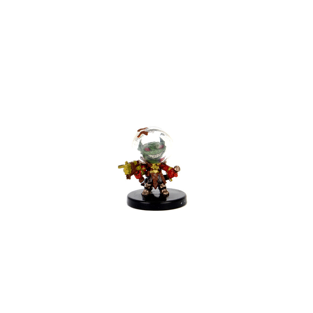 A grinning green goblin miniature in a space helmet and red armor holds a weapon