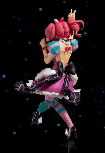Pink and turquoise striped anime figurine in a frilled purple dress and heels singing into a microphone